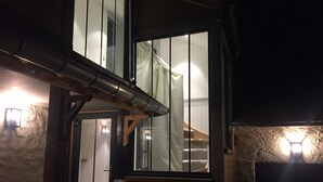 A staircase leading to a second floor with a wooden handrail and a metal banister. - Impressionist artist's house on the GR2 (La Roche-Guyon)