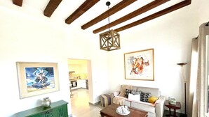 A living room with a sofa, coffee table, and artwork on the walls. - Broummana House (Broumana)