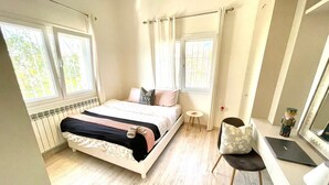 A bedroom with a bed, a desk, a chair, and a window. - Broummana House (Broumana)