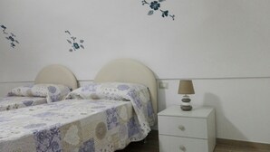 A bedroom with a bed, two nightstands, and a lamp. - CASA INCANTO, beautiful house with stunning views and parking space (Positano)