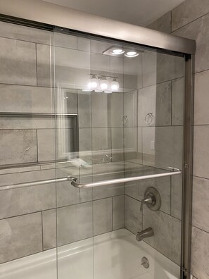 Combined shower/tub, hair dryer, towels, soap