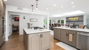 A modern kitchen with a central island, stainless steel appliances, and pendant lighting. - River Frontage! Family Friendly Mtn Retreat (Glenwood Springs)