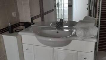 Bathtub, towels, soap, toilet paper