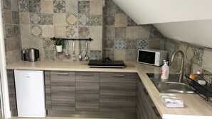 A modern kitchen with a built-in dishwasher, a microwave, and a sink.