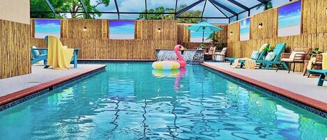 An indoor swimming pool with wooden walls, a wooden deck, and a glass ceiling.