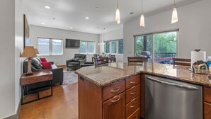 A modern kitchen with granite countertops, stainless steel appliances, and pendant lighting. - 57 Robber`s Roost #4 - Lionsback (Moab)
