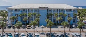 Stunning hotel with a central entrance and flat roof, surrounded by palm trees.