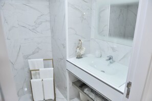 Shower, hair dryer, towels, toilet paper