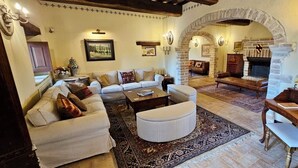 A cozy living room with a fireplace, a wooden desk, and a comfortable sofa set. - 360° views, pool, AC, pizza oven & bocce court (Casigliano, Acquasparta)