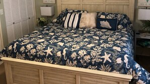 A bedroom with a bed, a ceiling fan, a nightstand, a lamp, and a door. - NEED SPACE? Entire Townhouse-Large 2-Bdrm 1,150sf Steps to Beach. 5% Off 7Nights (Myrtle Beach)