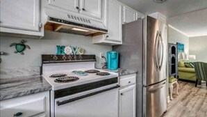 A kitchen with white cabinets, a stainless steel refrigerator, and a stove. - NEED SPACE? Entire Townhouse-Large 2-Bdrm 1,150sf Steps to Beach. 5% Off 7Nights (Myrtle Beach)