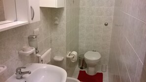 A bathroom with a sink, toilet, and shower area. - Apartment - Sleeps 3 & Swimming Pool (Realmonte)
