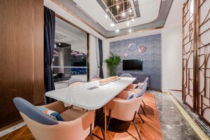 A modern conference room with a marble table, comfortable chairs, a large TV, and a decorative wall. - Yitel (Shanghai)