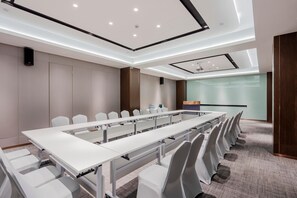 A conference room with a long table, chairs, and a presentation screen. - Yitel (Shanghai)