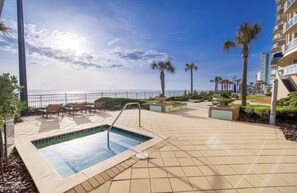 Relax by the ocean-view pool, surrounded by lush gardens and comfortable lounge seating.