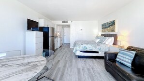 A compact hotel room with a bed, a sofa, a dining table, and a kitchenette. - Instaworthy-Prestigious Sunny Isles Beach. Direct beach access from building (Sunny Isles Beach)