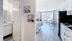 A modern apartment with a kitchen, dining area, and balcony with city views. - Instaworthy-Prestigious Sunny Isles Beach. Direct beach access from building (Sunny Isles Beach)