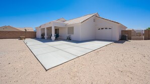 A single-story house with a flat roof and a covered patio area. - Mohave desert retreat  (Fort Mohave)