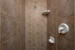Combined shower/bathtub, hair dryer, towels, toilet paper