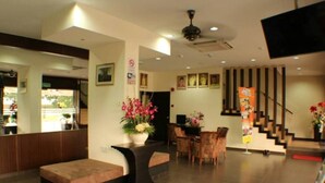 A modern hotel lobby with a reception desk, seating area, and staircase. - D&f BOUTIQUE HOTEL SENAWANG (Seremban)