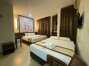 A hotel room with two beds, a desk, and a large floral artwork on the wall. - D&f BOUTIQUE HOTEL SENAWANG (Seremban)