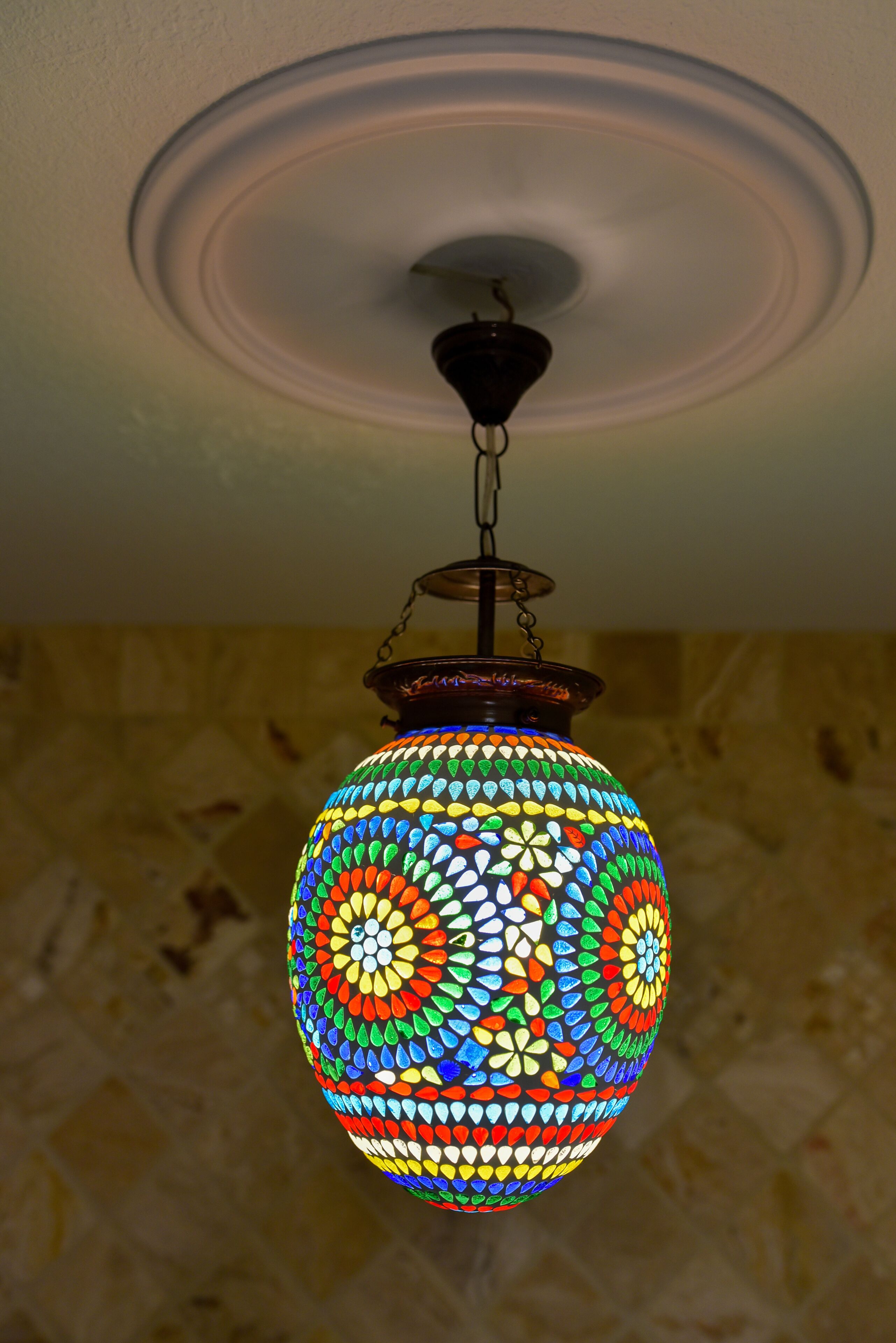 A colorful mosaic lamp hanging from the ceiling.