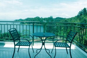 Enjoy a peaceful view of the surrounding forest and water from this balcony.