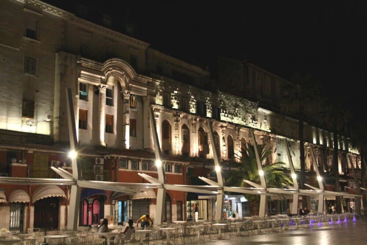 A historic building with classical architecture, featuring arched windows and columns.