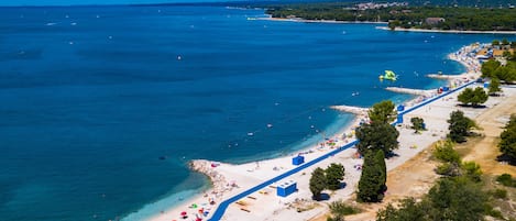 On the beach, sun loungers, beach towels