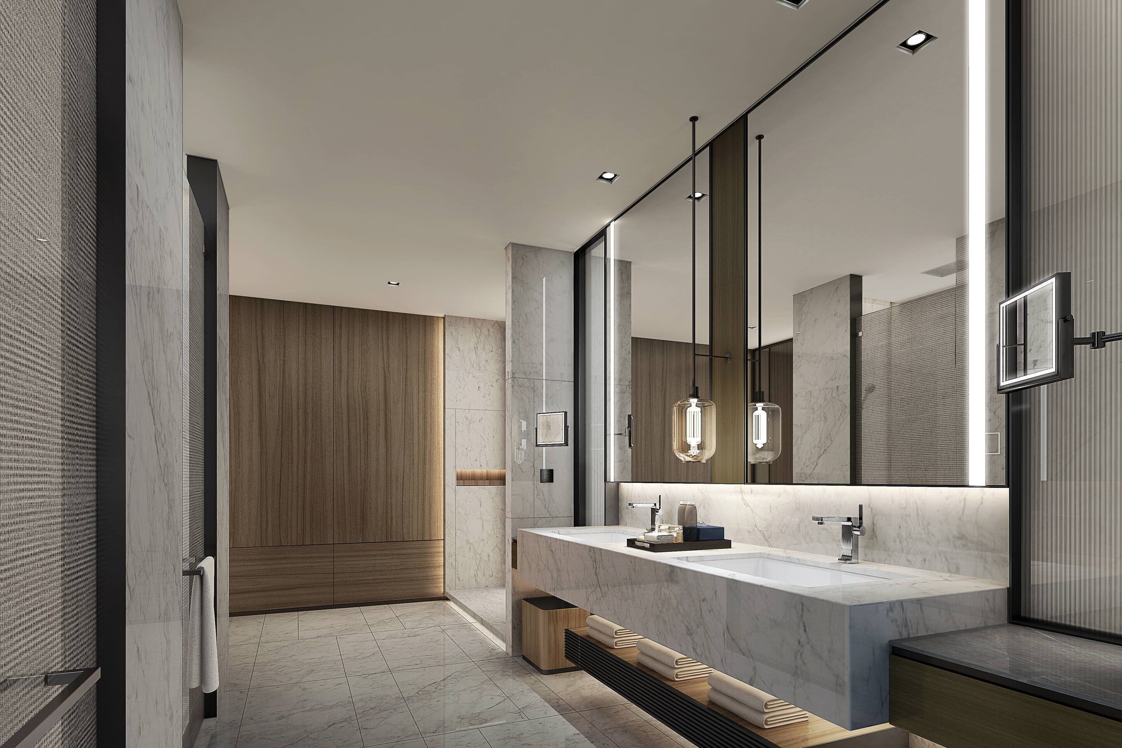 A modern bathroom with a large mirror, marble countertop, and wooden accents.