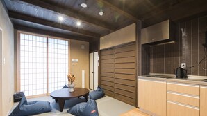 A modern kitchen with a wooden countertop, a built-in stove, and a sliding door closet. - No.8 Kyoto (Kyoto)