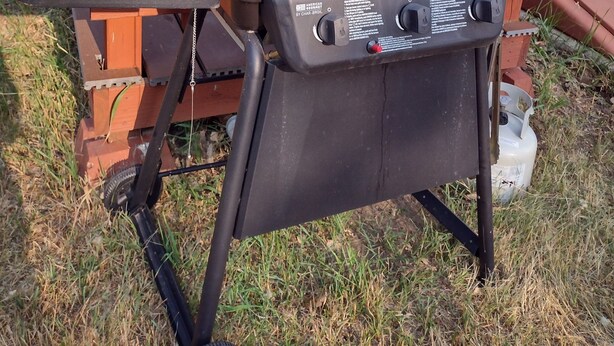 A portable grill with a control panel, placed outdoors. - The Red House (Rapid City)