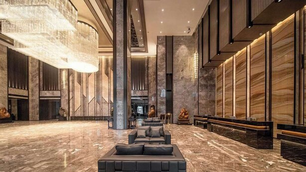 A spacious lobby with a large seating area, marble flooring, and a modern chandelier. - Ramada Plaza by Wyndham Hezhou North (Hezhou)