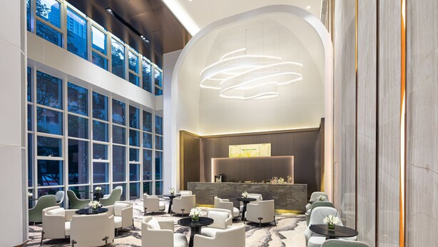 A spacious lobby with multiple seating areas, large windows, and a modern reception desk. - Wyndham Garden Wuhan Hankou (Wuhan)