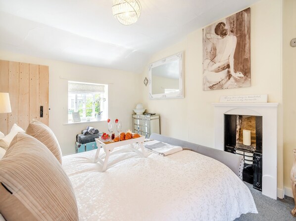 A bedroom with a large bed, a fireplace, a window with a view, and a painting on the wall. - Escape to the country to the beautiful Moors market town of Pickering. (Pickering)