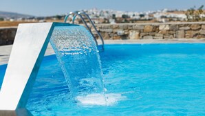 A swimming pool with a water feature.