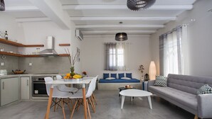 A modern living space with a kitchen, dining area, and seating area.