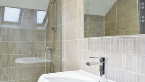 A bathroom with a shower, a sink, and a mirror. - 1 bedroom accommodation in Merthyr Cynog, near Brecon (Merthyr Cynog, near Brecon)