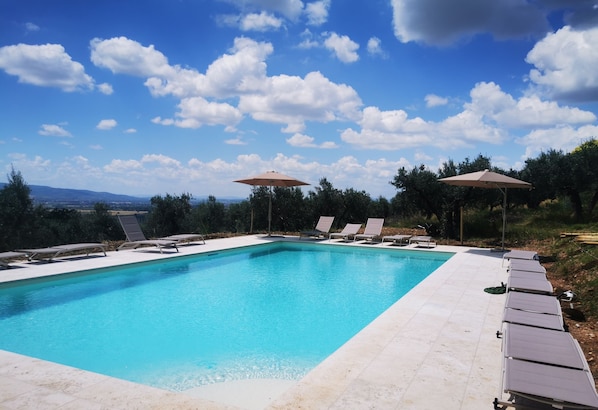 Seasonal outdoor pool, open 9:00 AM to 8:30 PM, pool umbrellas