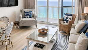A living room with a sofa, armchairs, a coffee table, and a TV. - Oceanfront and beachfront with absolutely unbelievable views! (Destin)