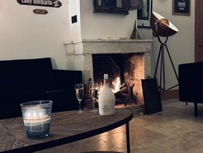 Enjoy a warm evening by the fireplace, complete with a bottle of wine and comfortable seating.