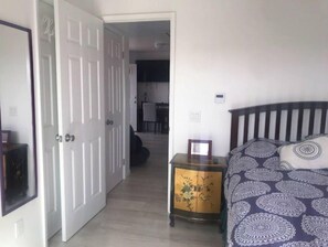 Cozy retreat with a neatly made bed and a bedside table.