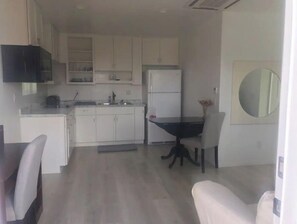 Enjoy cooking in this well-equipped kitchen with oven and refrigerator.
