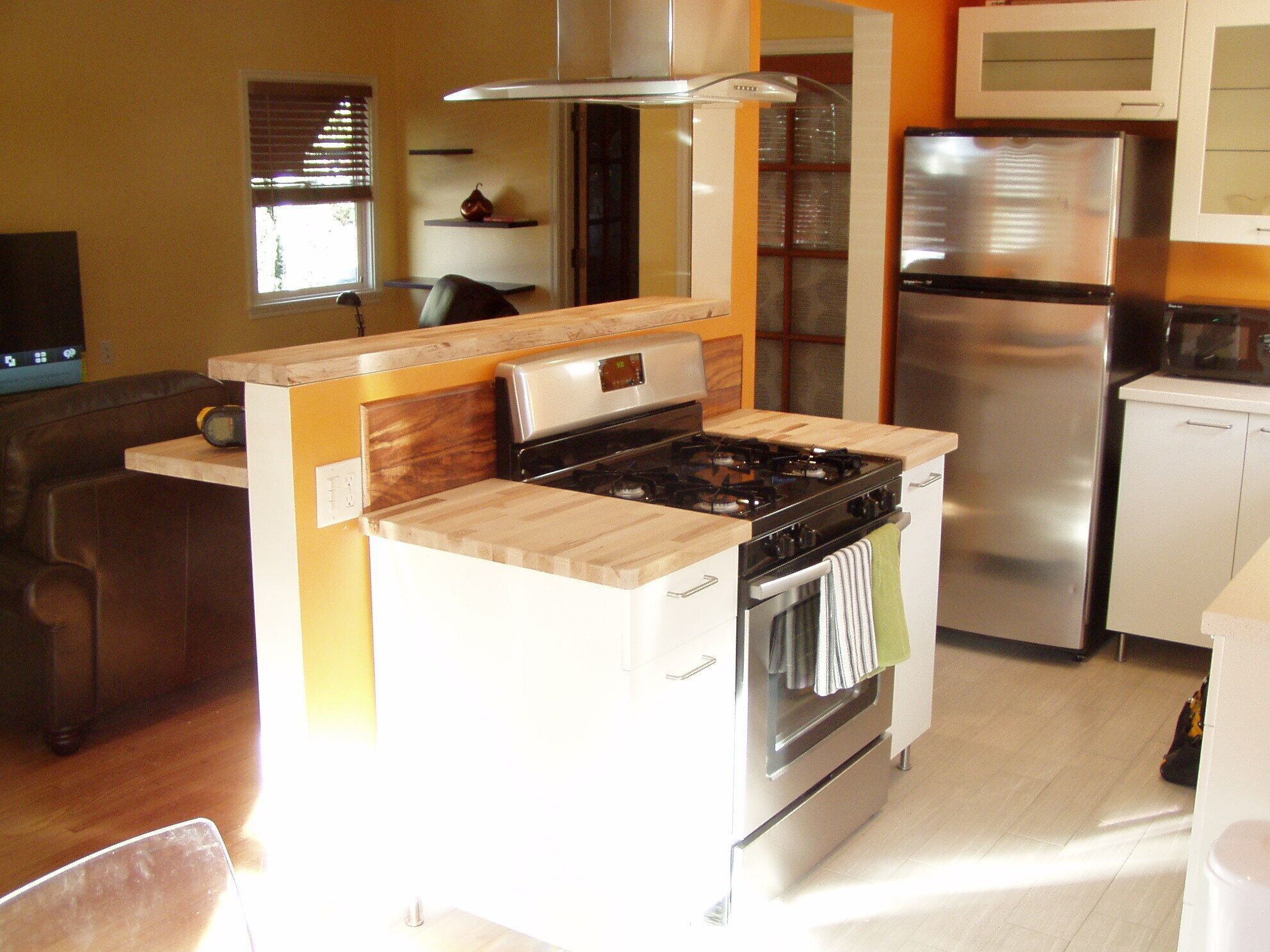A compact kitchen with a stove, oven, and refrigerator.