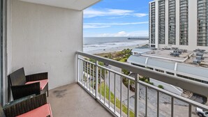 A balcony with a view of the ocean and a parking area. - S Hampton 704A Studio Oceanview in Kingston, Pool (Myrtle Beach)
