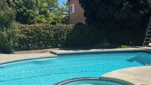 A clear swimming pool with a tiled edge and a circular hot tub area. - Rare to find house of 5 BR and 4 Bath with big backyard in Fountain Valley.  (Fountain Valley)