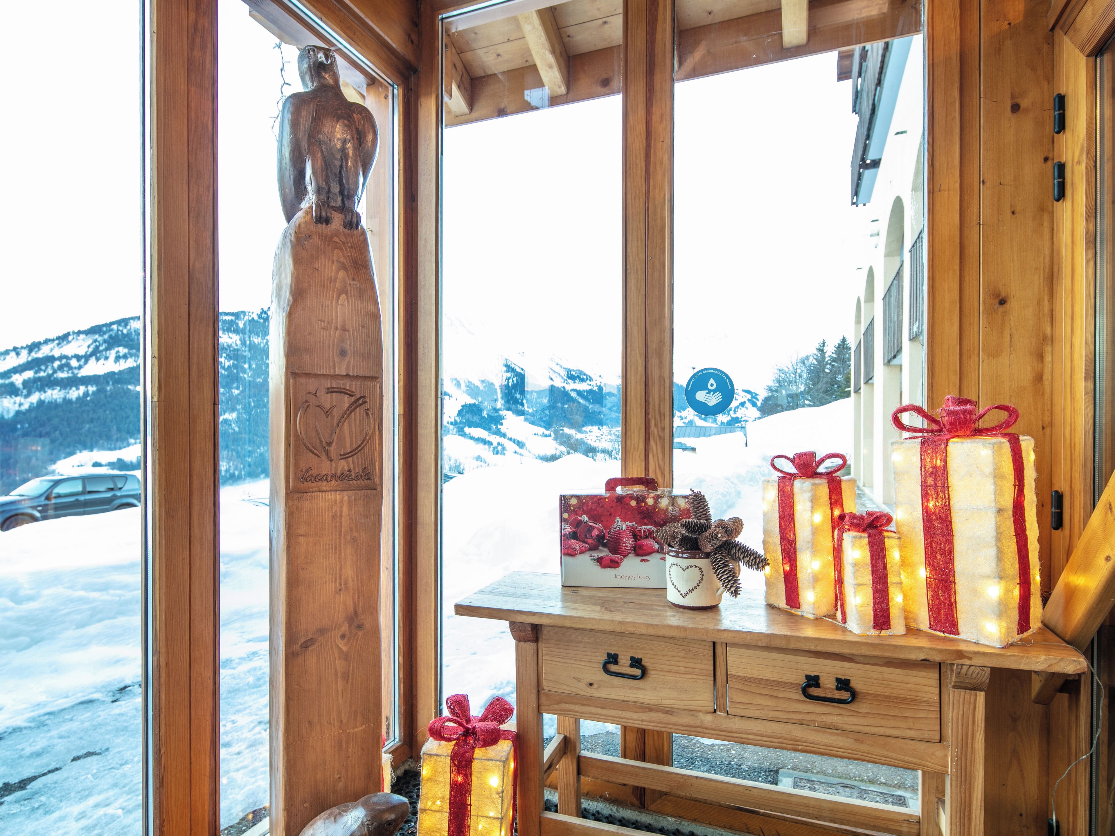 A wooden interior with a window view of a snowy landscape.