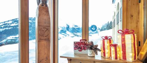A wooden interior with a window view of a snowy landscape.