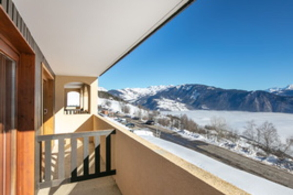 A balcony with a view of snow-covered mountains.