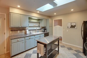 A kitchen with light blue cabinets, a granite countertop, a built-in oven, and a skylight. - 0651: Central Salida Home 5 Blocks to Dtwn & River (Salida)